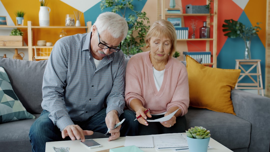 Elderly couple reviewing documents at home